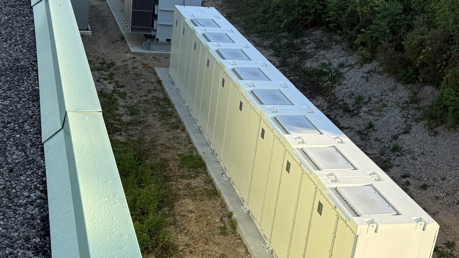 Row of battery storage enclosures at a manufacturing plant in Woodstock, Ontario